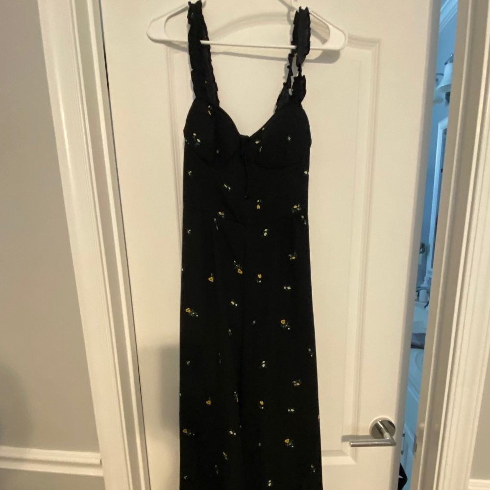 Black jumpsuit with yellow follows
